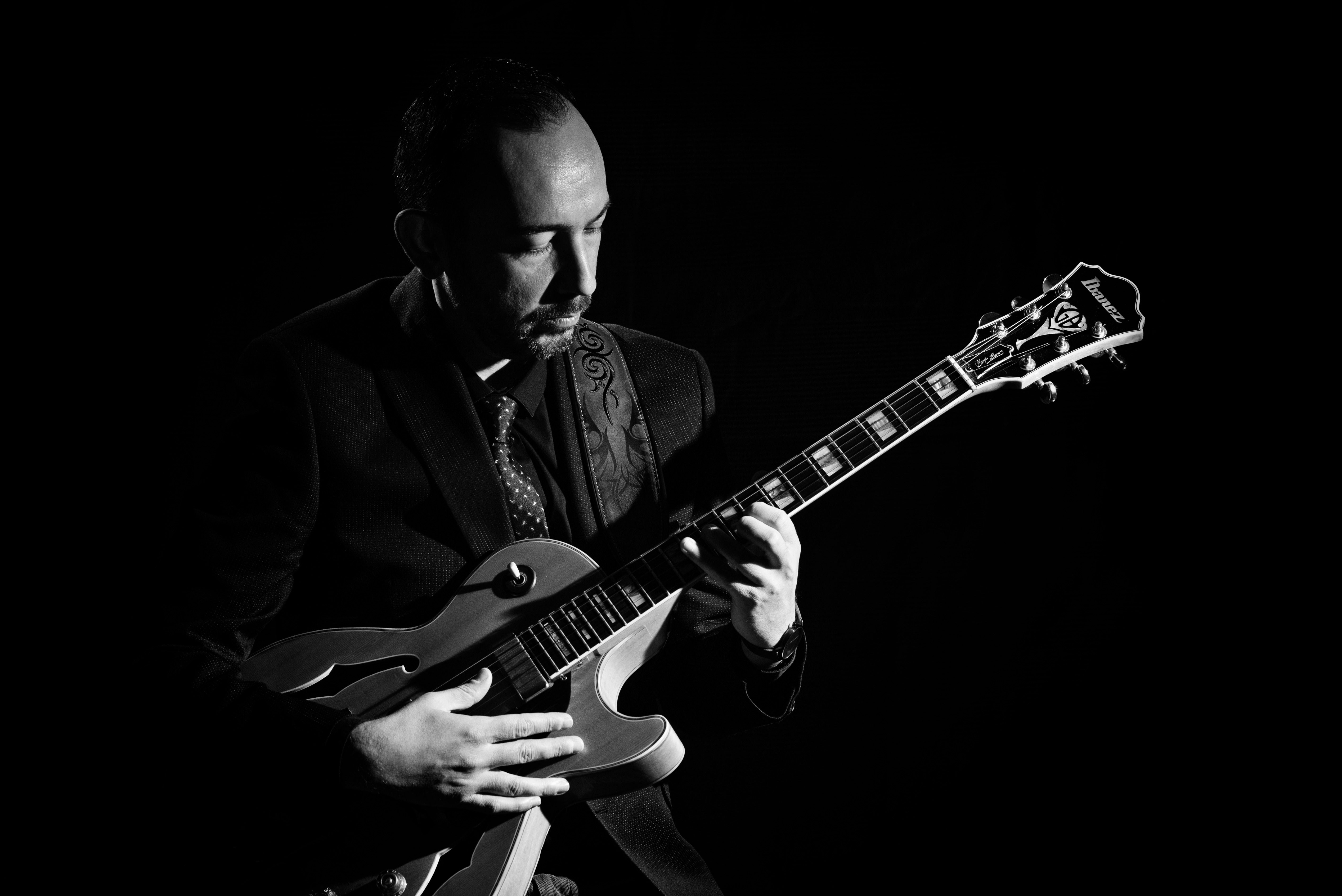 George Koutsi playing guitar